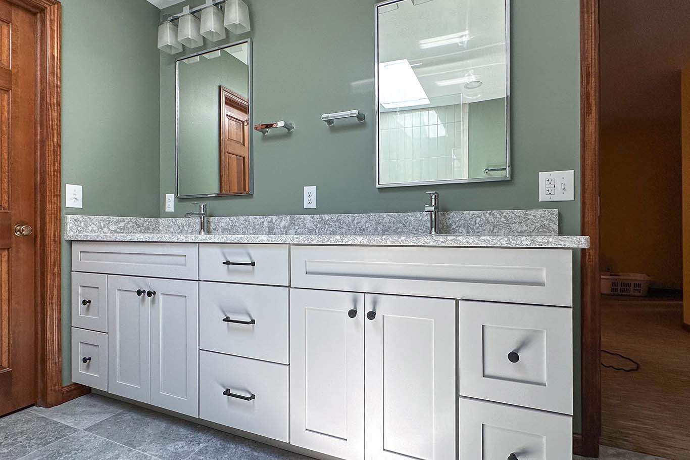 This bathroom remodeling dayton ohio features white bathroom cabinetry